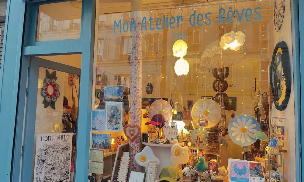 This is an image of a photo taken fron the outside of a shop window with a bunch of cool gifts and homewares inside.