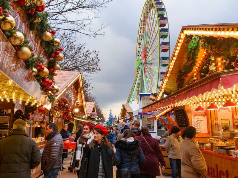 This is an image of a Christmas market with lights, decorations and more.