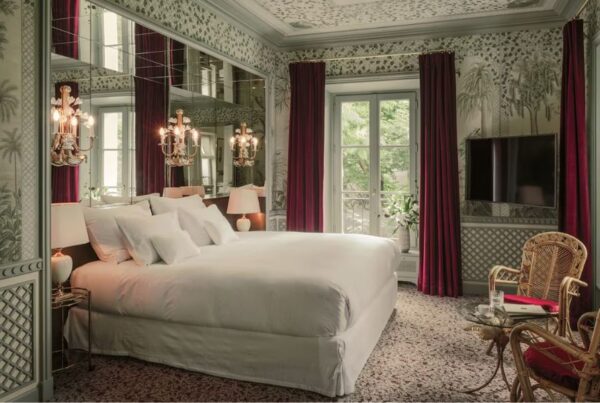 This is an image of a really nice hotel room in Paris with royal decor and chandelier lamp lights.