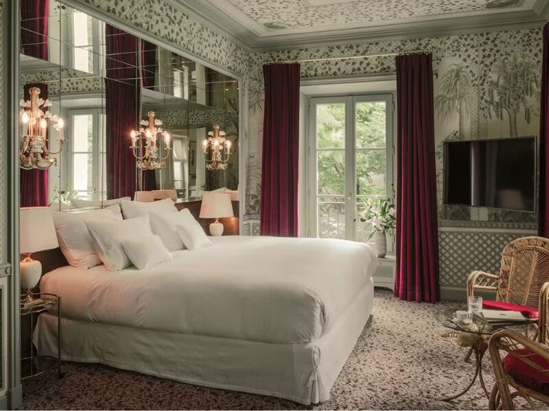 This is an image of a really nice hotel room in Paris with royal decor and chandelier lamp lights.