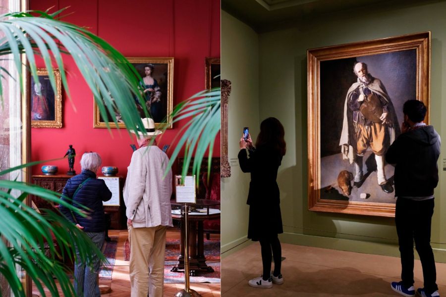 This is an image of an art gallery and museum with pictures hung up on the walls and people looking at them.