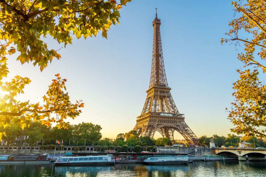 This is an image of the Eiffel Tower in the distance against a blue sky.