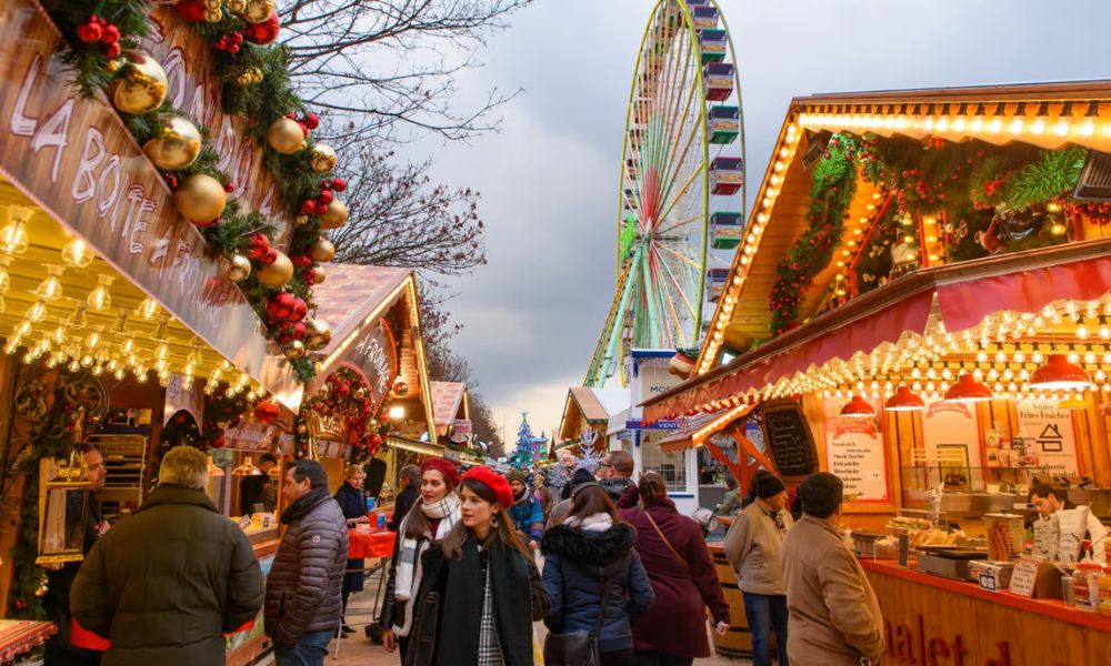 This is an image of a Christmas market with people milling around and looking at all the stores.