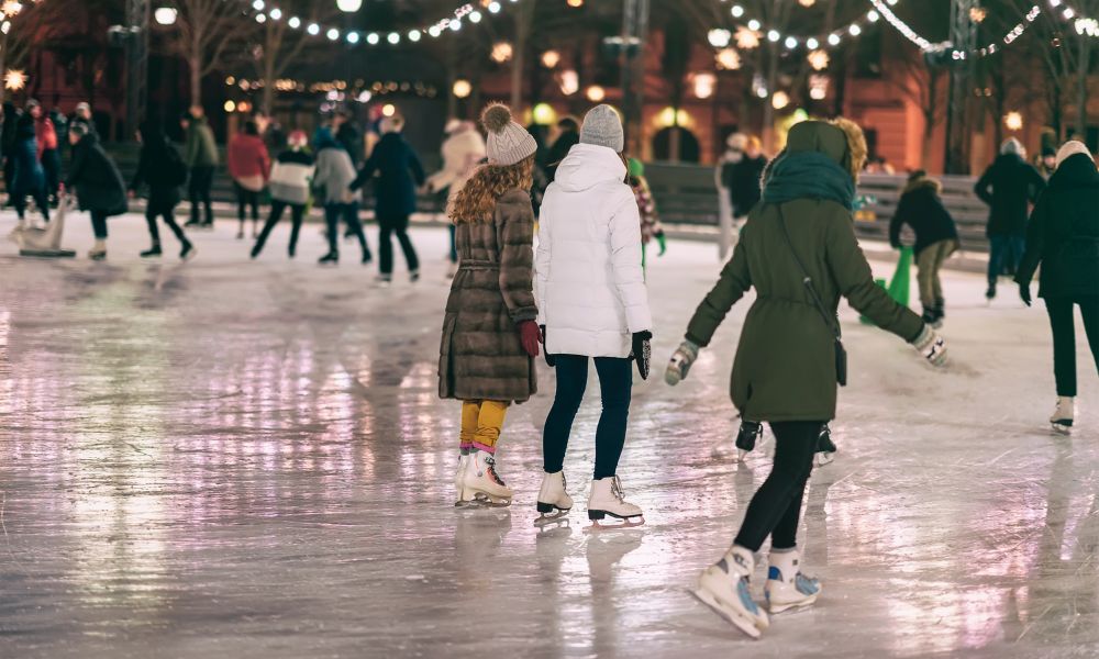 This is an image of people ice skating around an ice rink with one another.