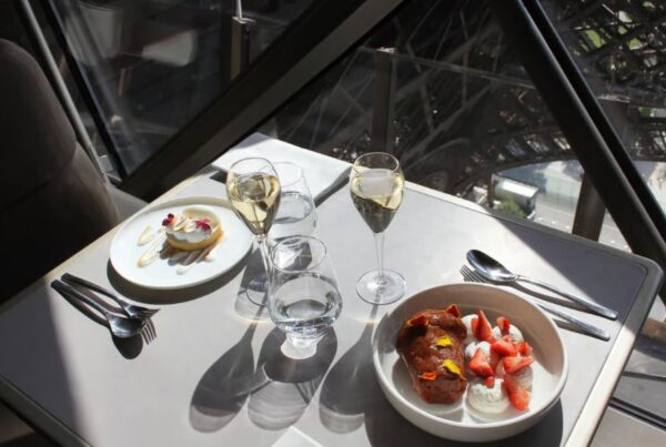 This is an image of a top dining meal on the Eiffel Tower with sun streaming in the weekend.
