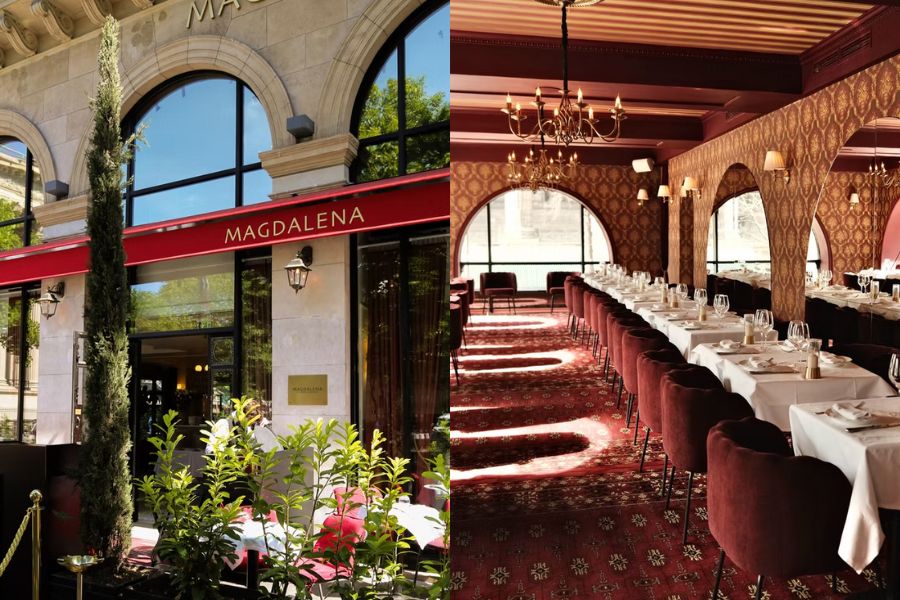 This is an image of a really nice restaurant with plants out front. To the right is a room with a nice chandelier, lovely tables set up with tableware and cutlery, plus big arch mirrors set up around.