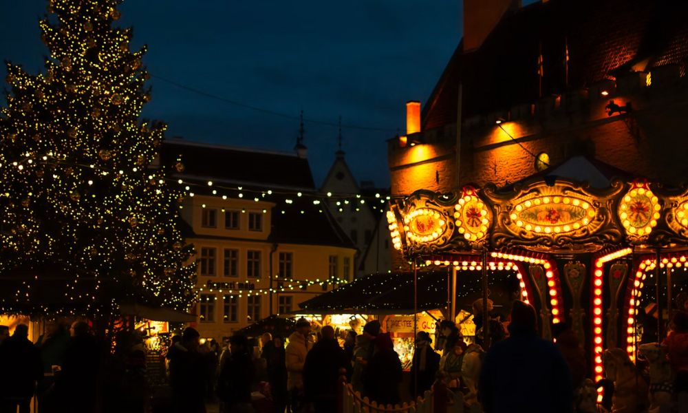 This is an image of a little Christmas market in Bercy village with a merry-go-round, Christmas tree and more.