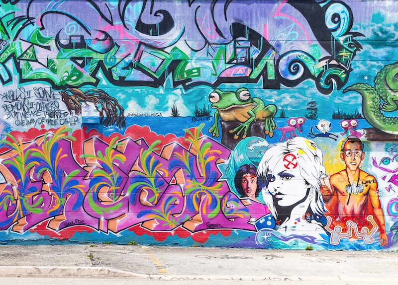 This is an image of bright and colourful graffiti on a big wall.