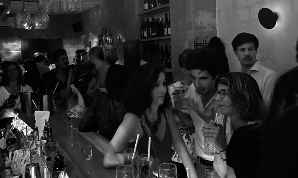 This is an image of a small group of people chatting and talking in a wine bar.