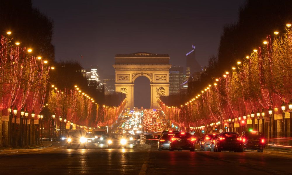 This is an image of the Champs Elysees (the road leading up to the Arc de Triomphe) and all the trees are dressed with Christmas lights.