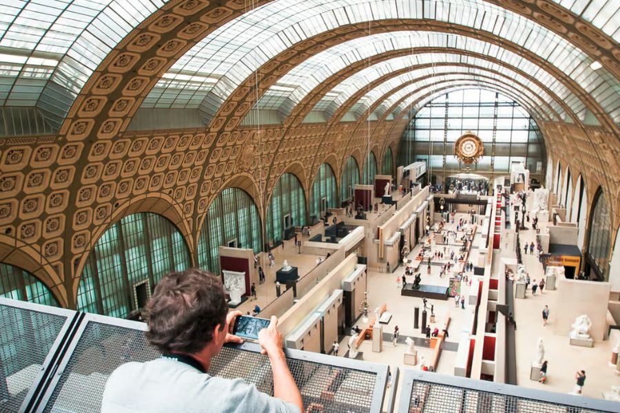 This is an image of a big museum hall filled with different aisles and rooms full of art.