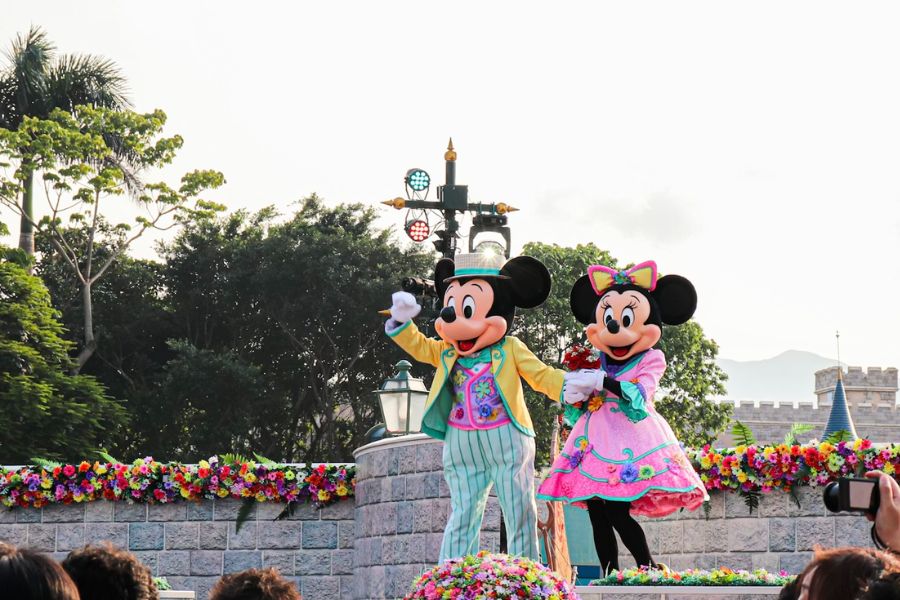 This is an image picture of Mickey and Minnie dressed up and waving to everyone.