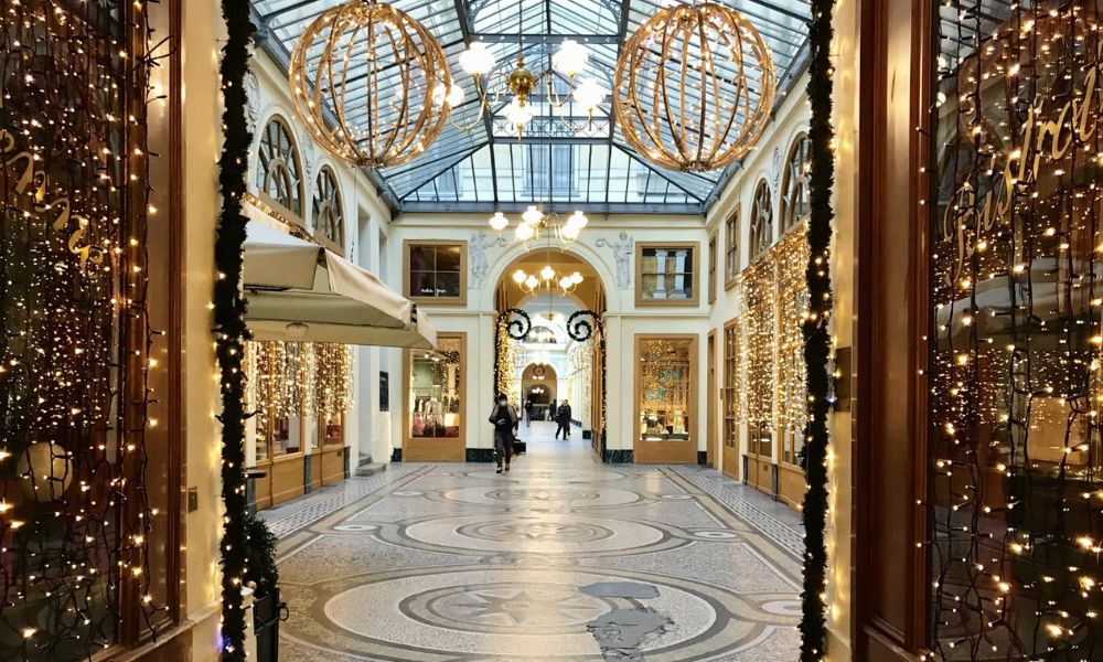 This is an image of a little passageway dressed up with Christmas lights and baubles.