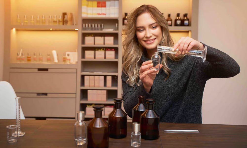 This is an image of a lady making perfume at a table.
