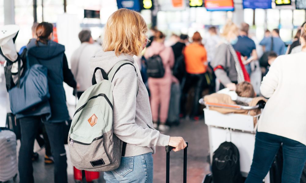 This is an image of a person standing in the check-in line at the airport.