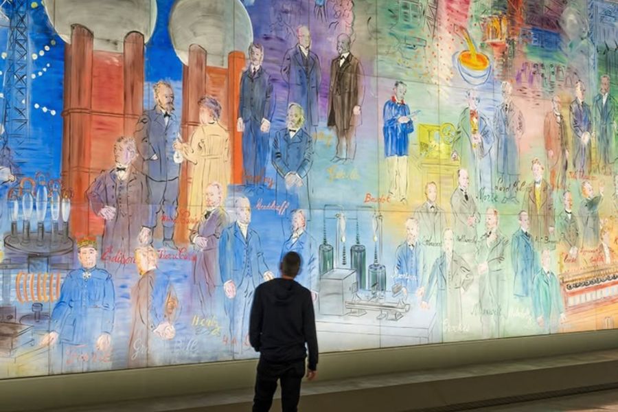 This is an image of a man standing in front of a big technicolour wall.