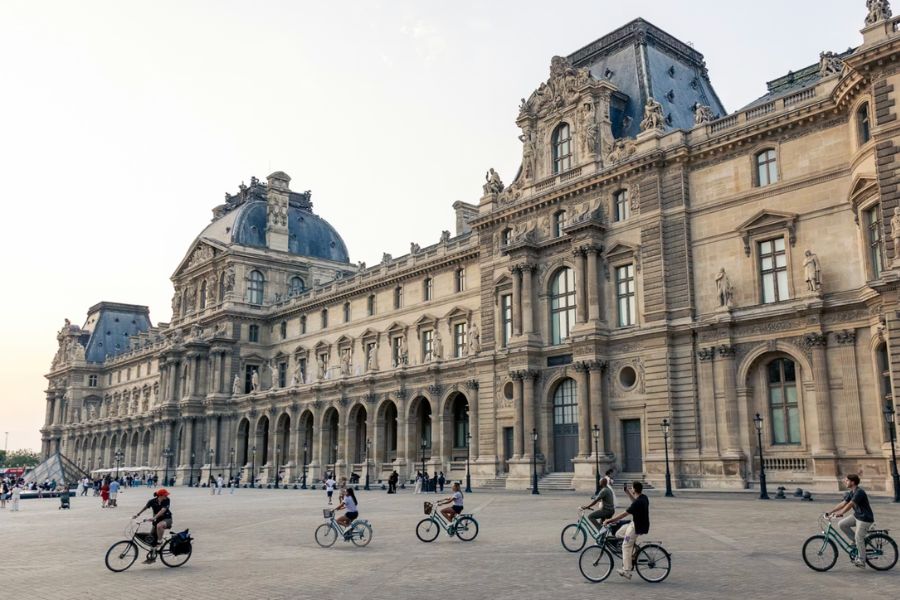 This is an image of a bike tour group riding around the Louvre.