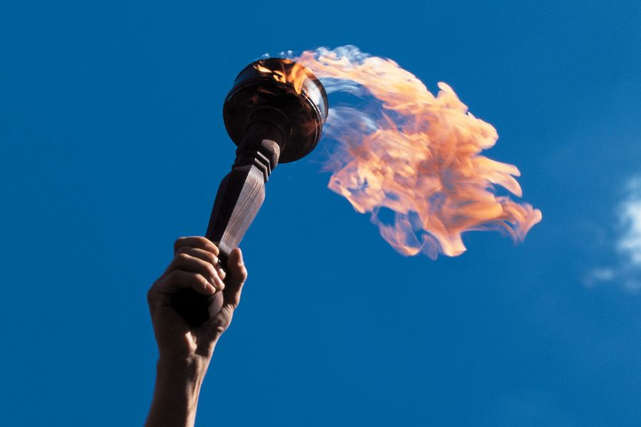 This is a picture of the Olympic Torch being held in the air.