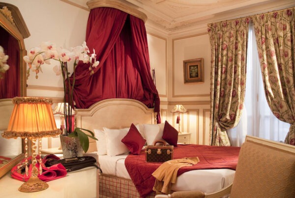 This is an image of a grand and luxurious hotel bedroom with decadent furniture.