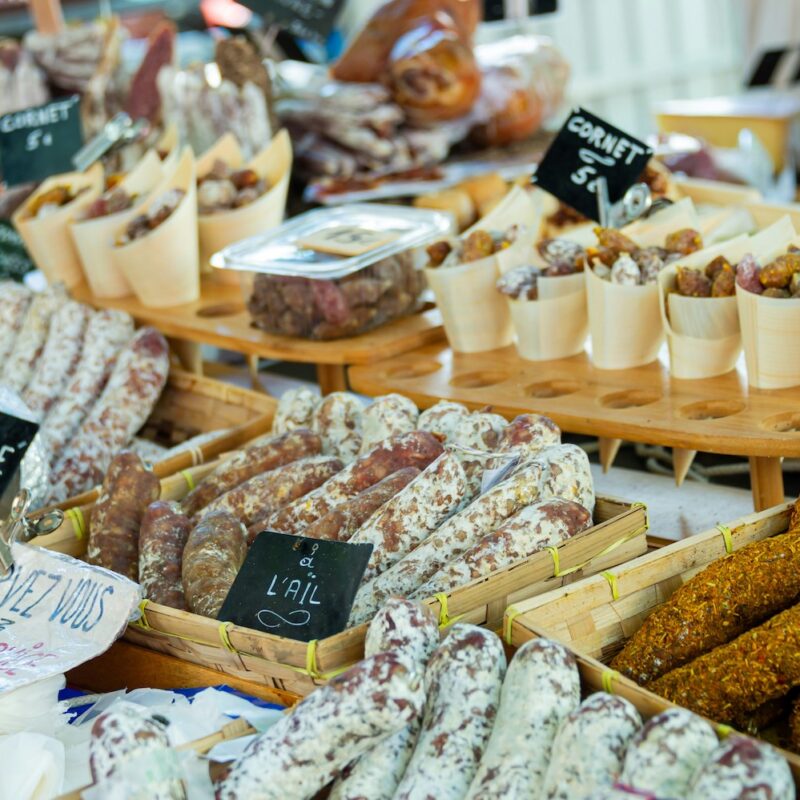 This is an image of a shop displaying a wide variety of different French deli meats.