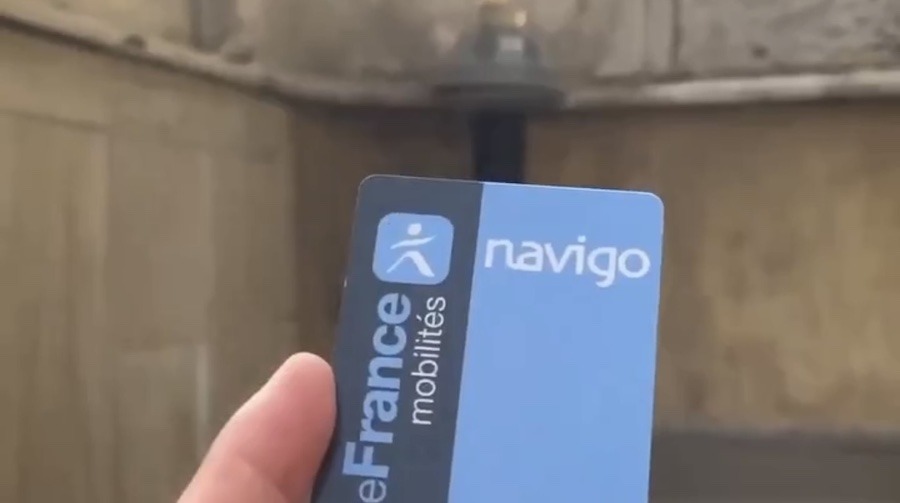 This is an image of someone holding a blue Navigo card.