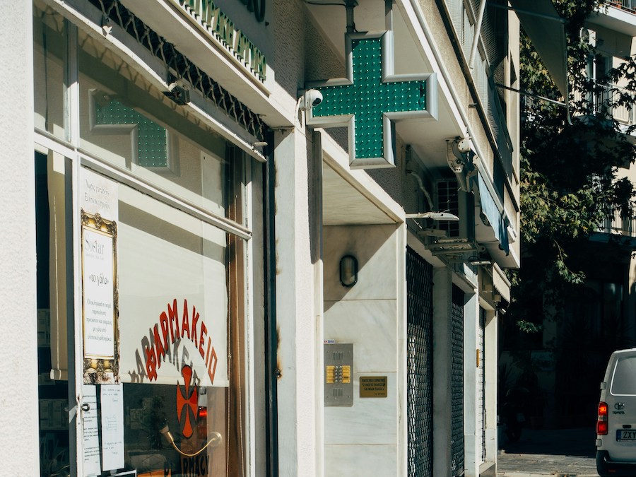 This is an image of the outside of a pharmacy. This is indicated by a bright green cross that is outside. An important thing to know before visiting Paris is that doctor's appointments won't break the bank.