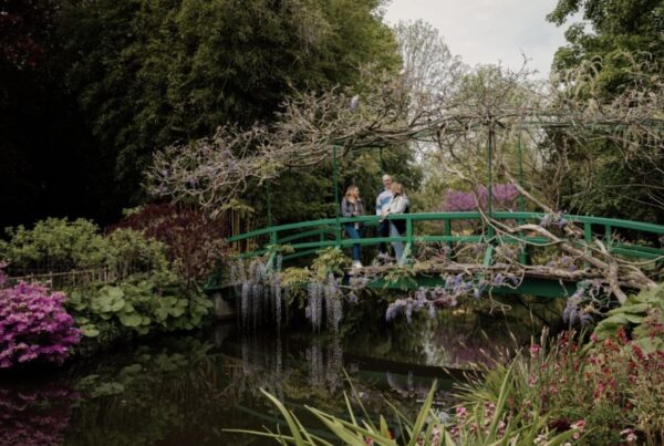 This is an image of a small group of people on a bridge in Monet's Giverny Gardens.