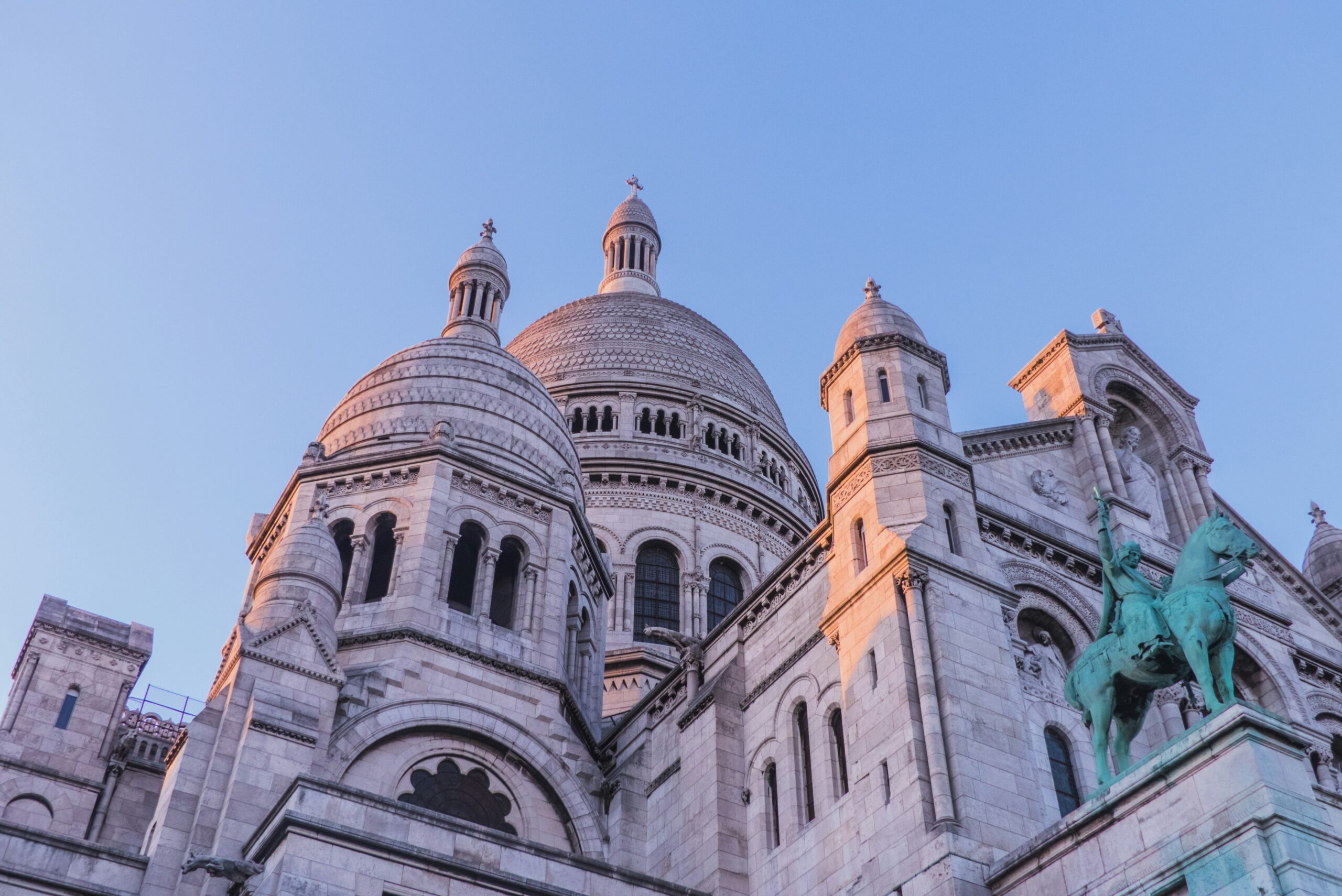 This is an image of the Sacre Coeur Cathedral at what looks like sunrise. An important thing to know before visiting Paris is that there are lots of free activities (including most churches and cathedrals).