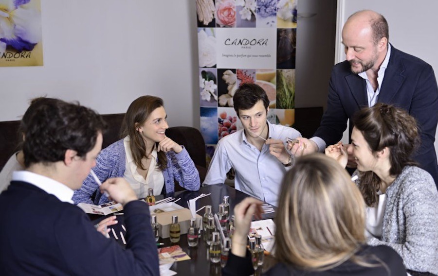 This is an image of a group learning how to make their own perfume mix. There is also an instructor explaining what needs to be done. Making your own perfume is a unique experience to try in Paris.